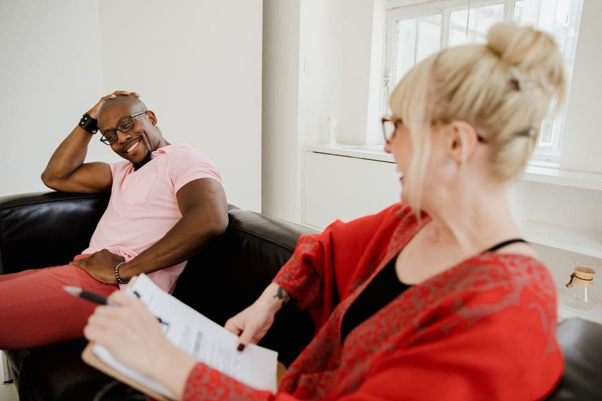 A smiling adult talking with a counselor