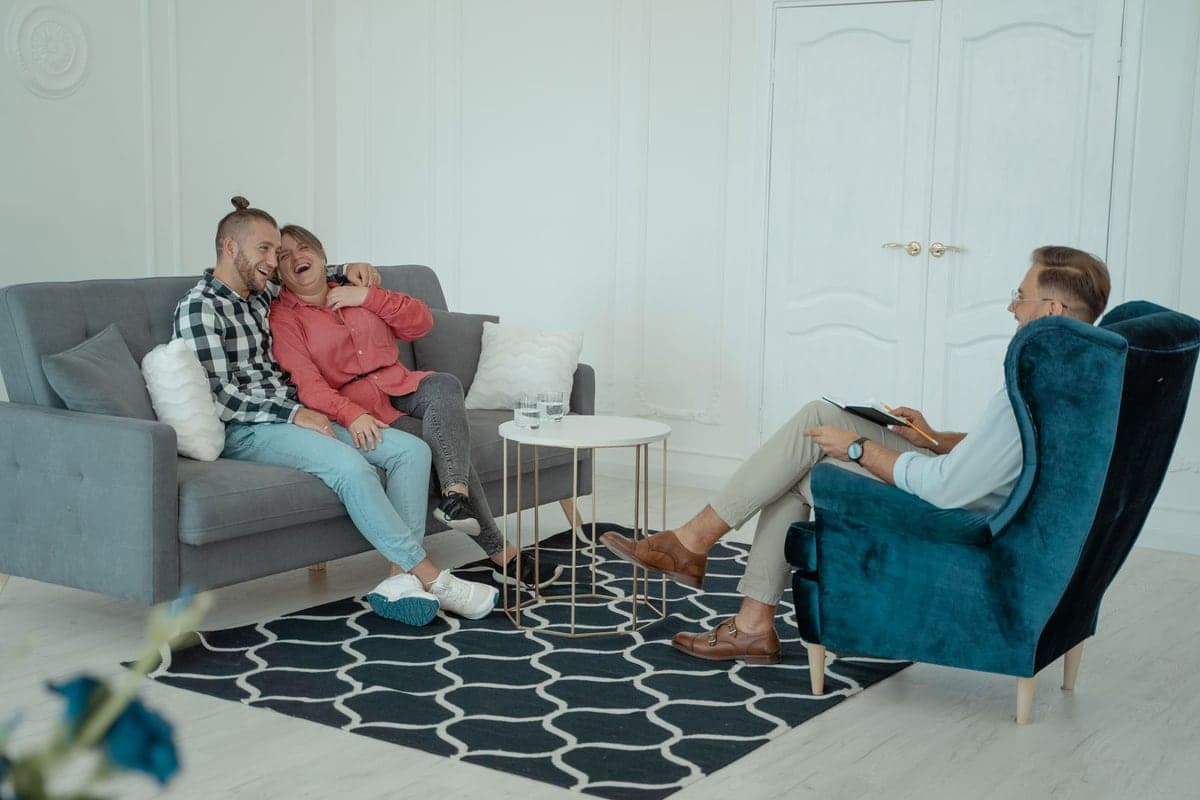 A happy couple laughing together during a counseling session